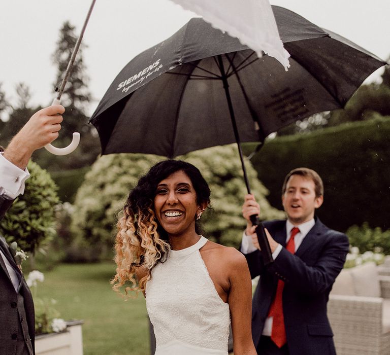 Bride wears white halter-neck reception gown | Joshua Gooding Photography