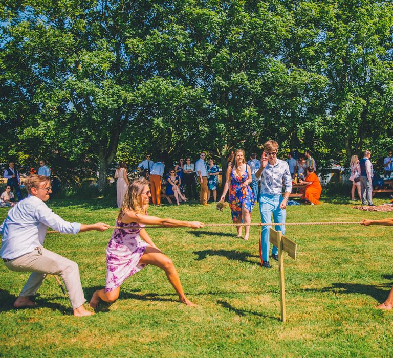 Wedding guests gather on the lawn for outdoor games on wedding day | Story + Colour