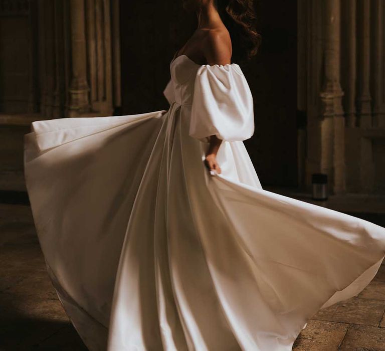 Bride in a Nortier Shallow wedding dress twirling in the shadows at Bodleian Library 