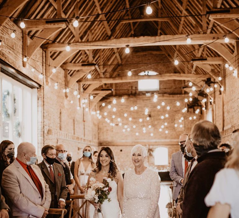 Bride walks down the aisle with her mother