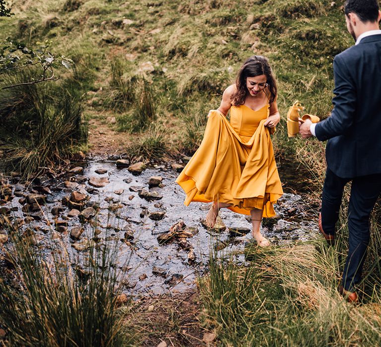 Bride & groom walk hand in hand with one another