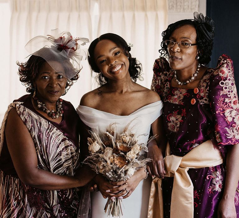 Bride stands with wedding guests on her wedding day