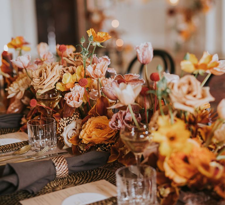 Pink, orange, peach and mocha wedding flower arrangement with roses and tulips 