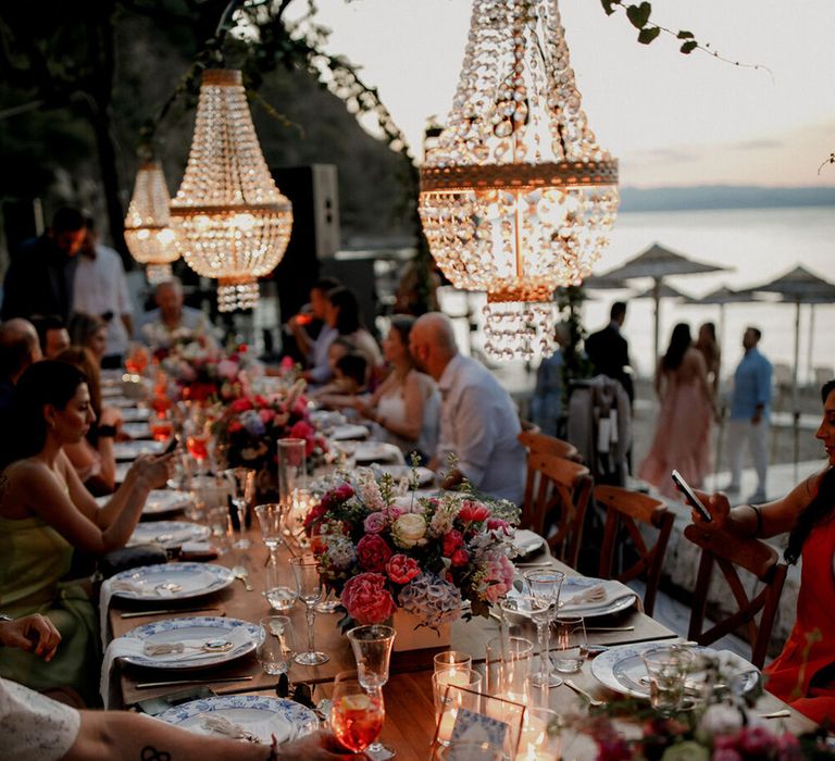 Banquet tables in front of sea setting as the sun begins to go down in Greece