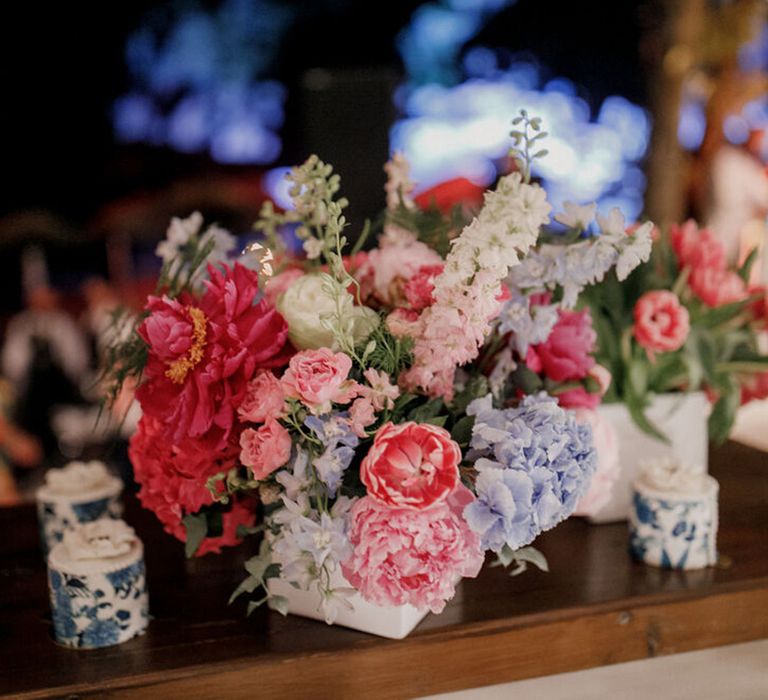 Bright florals sit on wooden table in Greece 