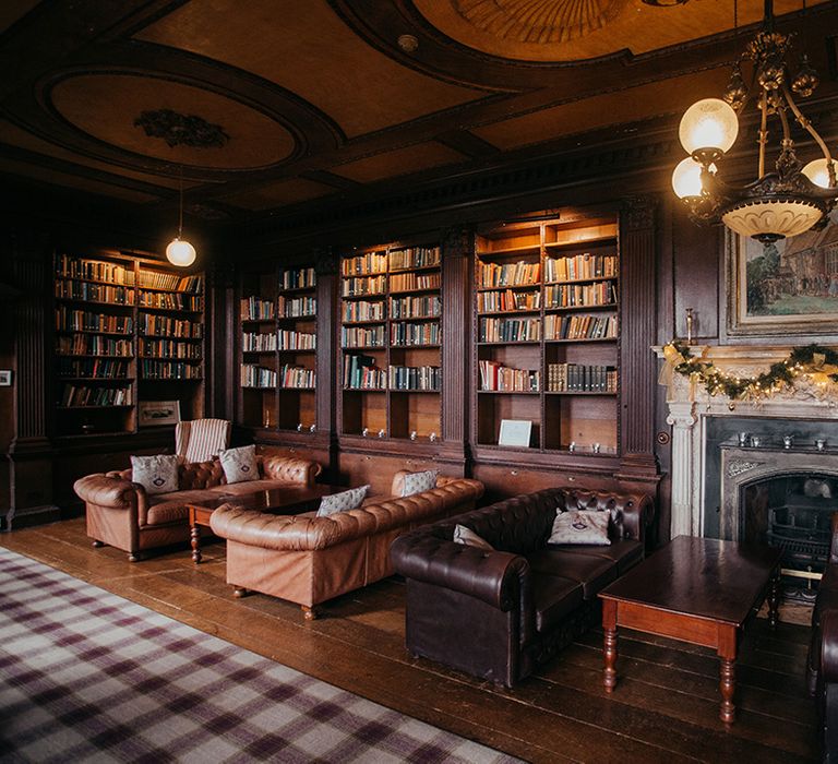 Gosfield Hall room complete with Christmas wreath across fireplace 