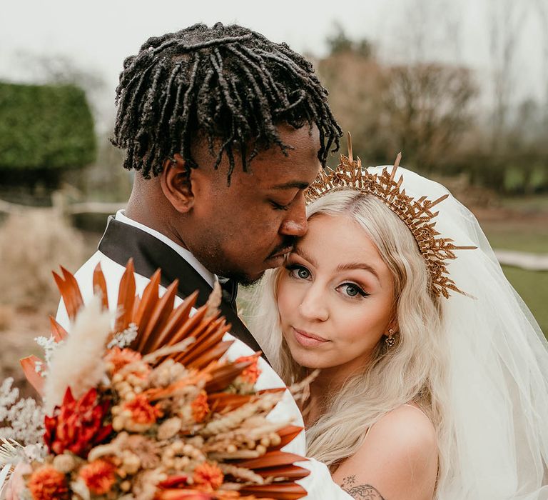 Orange dried flower bouquet for bride in gold wedding crown