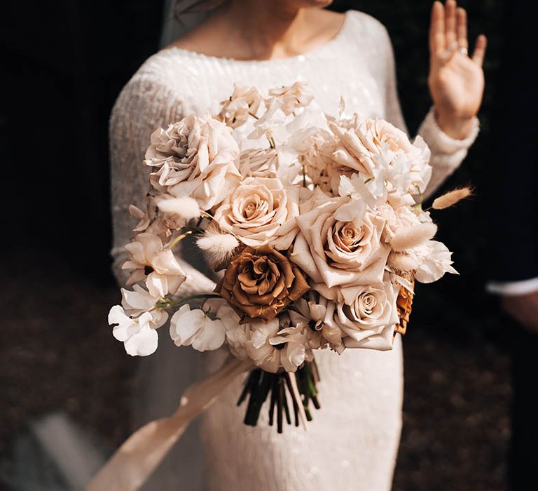 Wedding bouquet of toffee roses, pink and white roses and white orchids