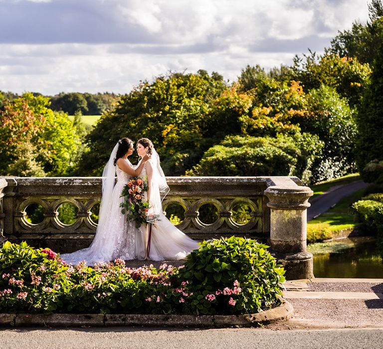 Lesbian wedding at Foxtail Barns wedding venue with brides holding each other