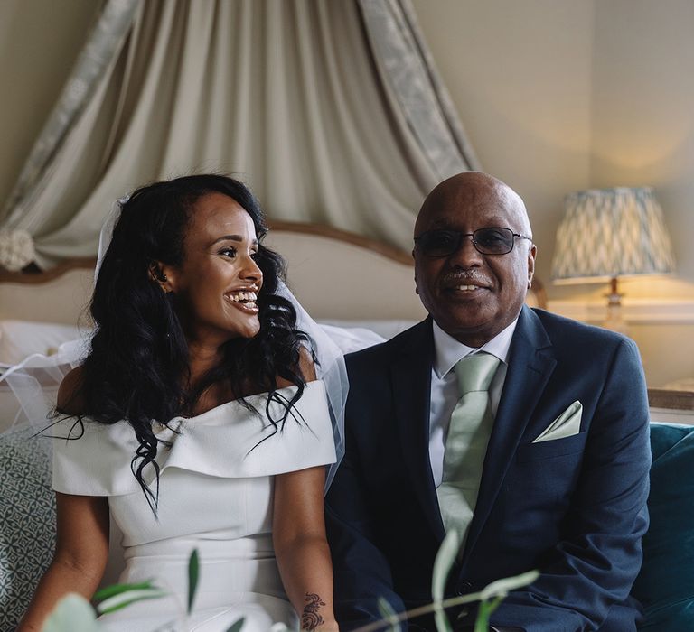 Bride in off the shoulder white wedding dress with father in blue suit with mint green tie and handkerchief 