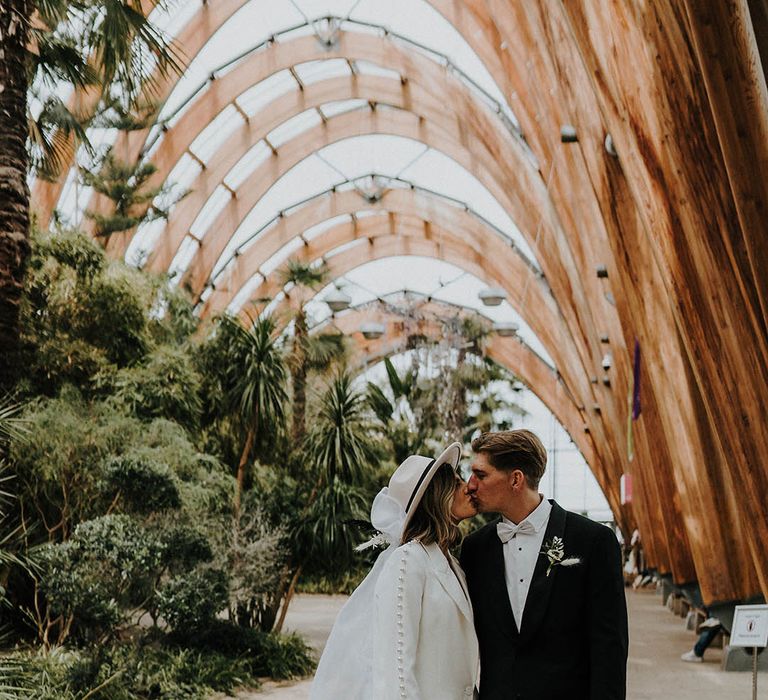 Bride and groom share a kiss at town hall wedding 