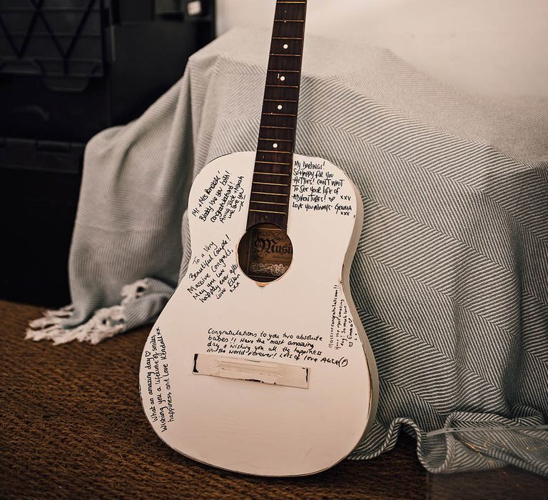 White painted guitar alternate guestbook idea for marquee wedding 