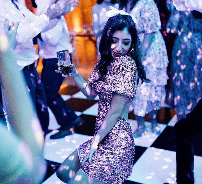 Bride in a pink sparkly evening reception dress at Elmore Court multicultural wedding