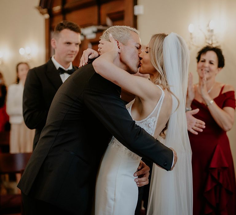 Bride and groom share their first kiss as a married couple after getting married at Chelsea Old Town Hall