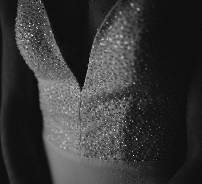 Close up of the bride's sparkly v-cut wedding dress