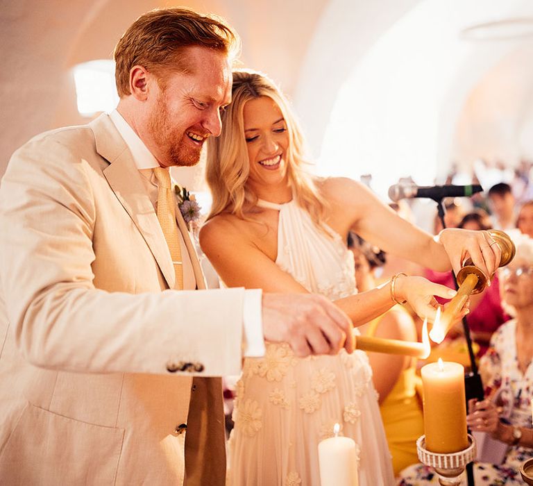 Bride and groom participate in the candle lighting ceremony 