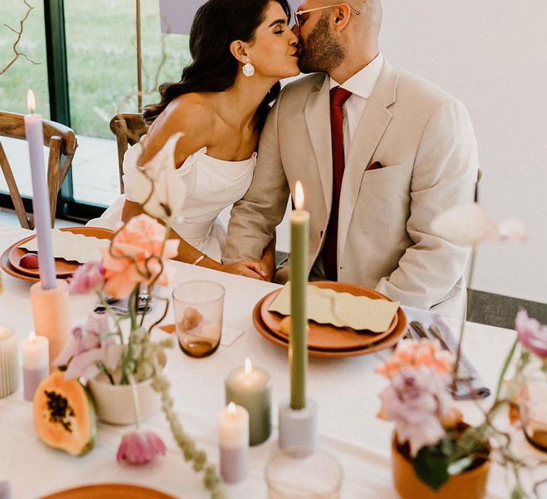 Lavender and white wedding sign with the bride and groom seated and kissing for their wedding reception 