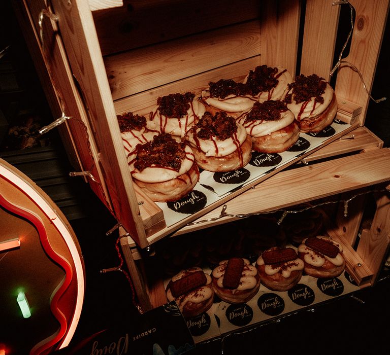 Doughnut wedding favours in wooden crate with fairylights around the sides