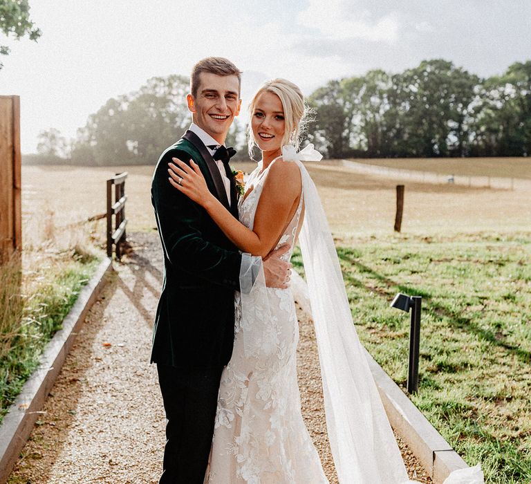 Bride in Made With Love wedding dress with the groom in velvet tuxedo at their rustic luxe wedding 