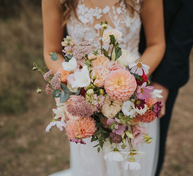 Pink dahlias, white cosmos, and more in pastel wedding bouquet 