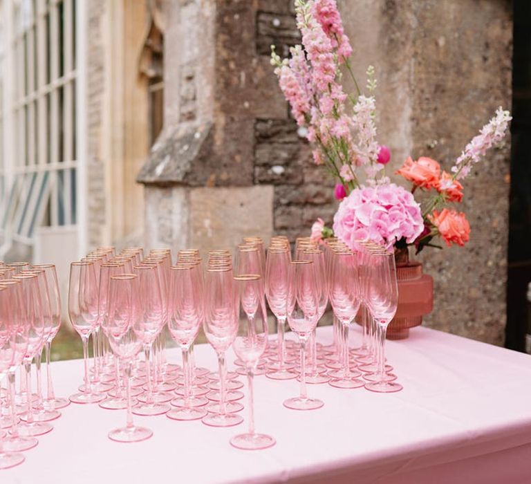 Pink tablecloth with pink champagne glasses for the wedding guests 