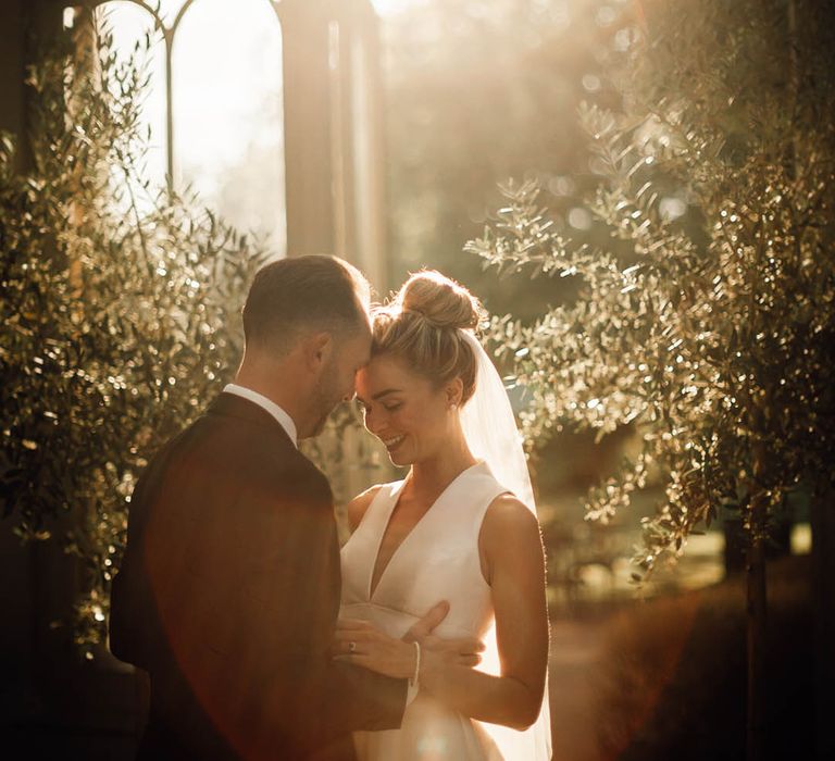 Golden hour wedding photo of the bride and groom at their classic wedding day 