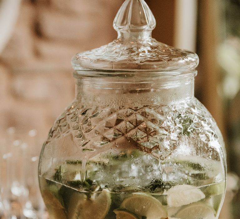 Wedding drinks station with drink filled with limes 