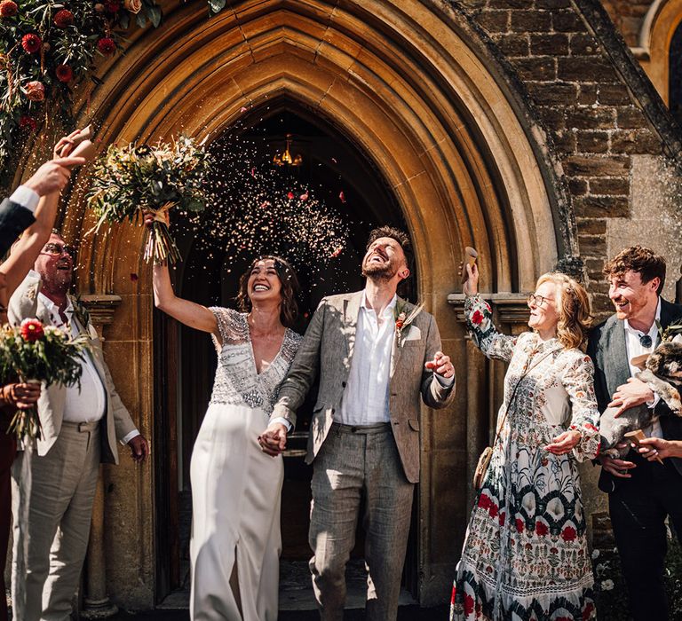 Dried petal confetti thrown over couple after their church wedding ceremony 