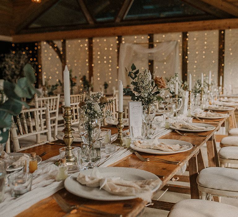 Rustic barn wedding venue decorated with fairy lights and neon signs