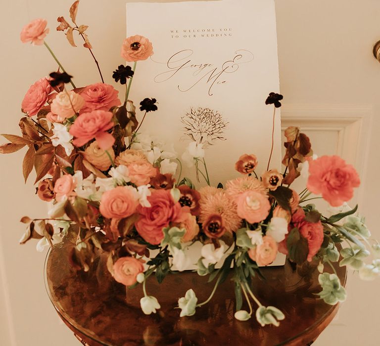 Wedding welcome decorations with autumnal flower arrangement and signage 