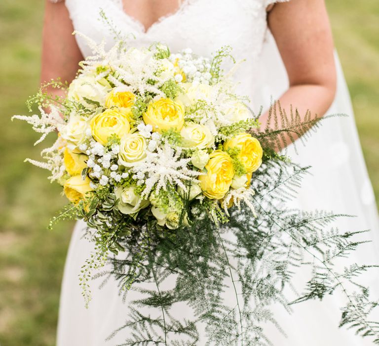 Yellow wedding bouquet with yellow and white flowers with foliage for yellow theme wedding 