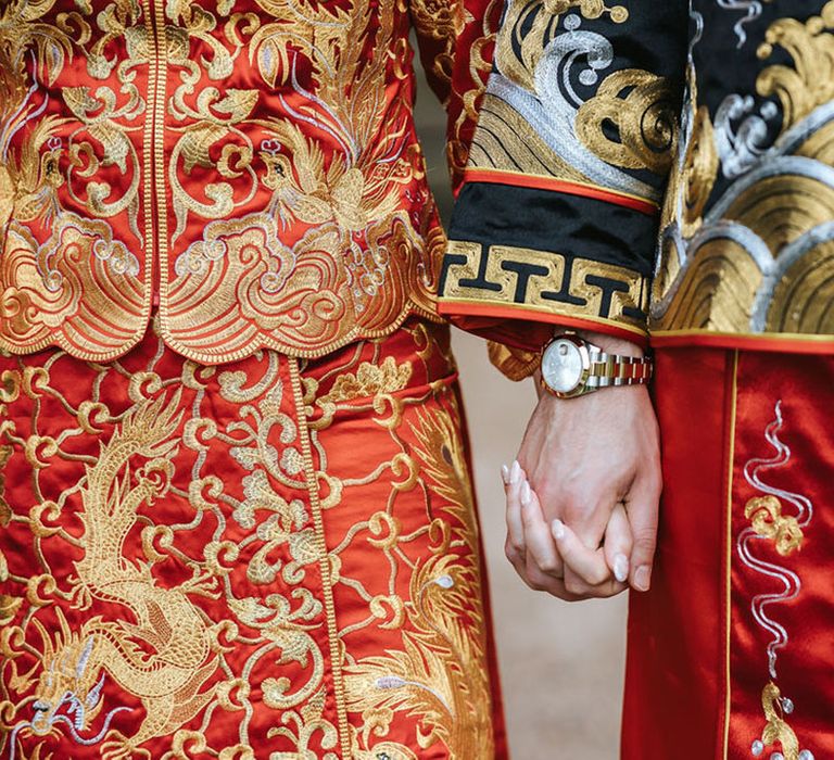 The bride and groom hold hands on their wedding day 