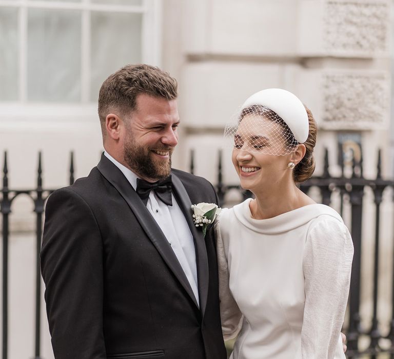 Bride laughs with a wedding guest at the city wedding 