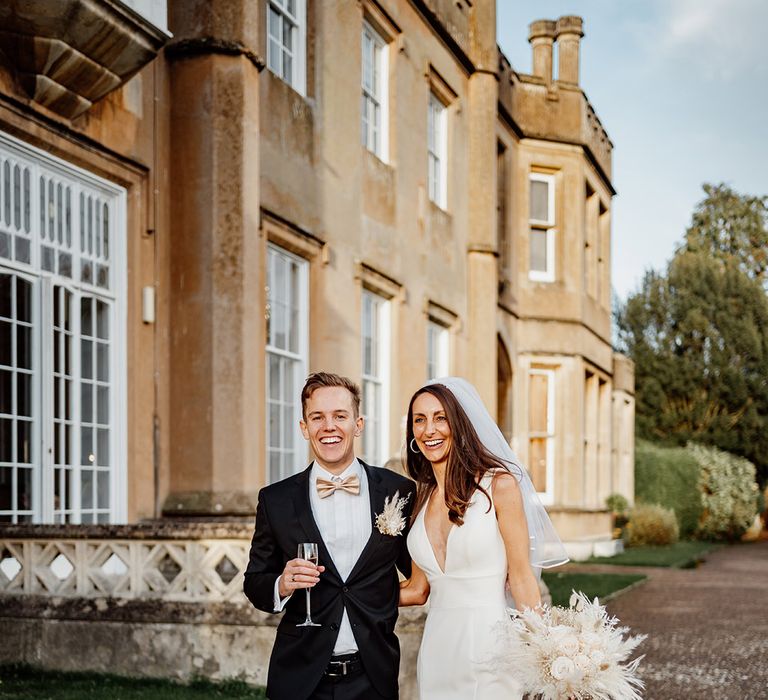 Nonsuch Mansion wedding venue with classic wedding attire including a dried boho wedding bouquet 