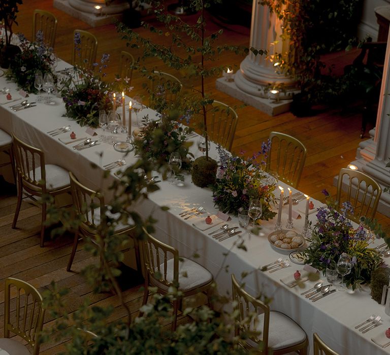 Banquet style wedding tables decorated with purple wedding flowers and minimalist white decorations for library wedding 