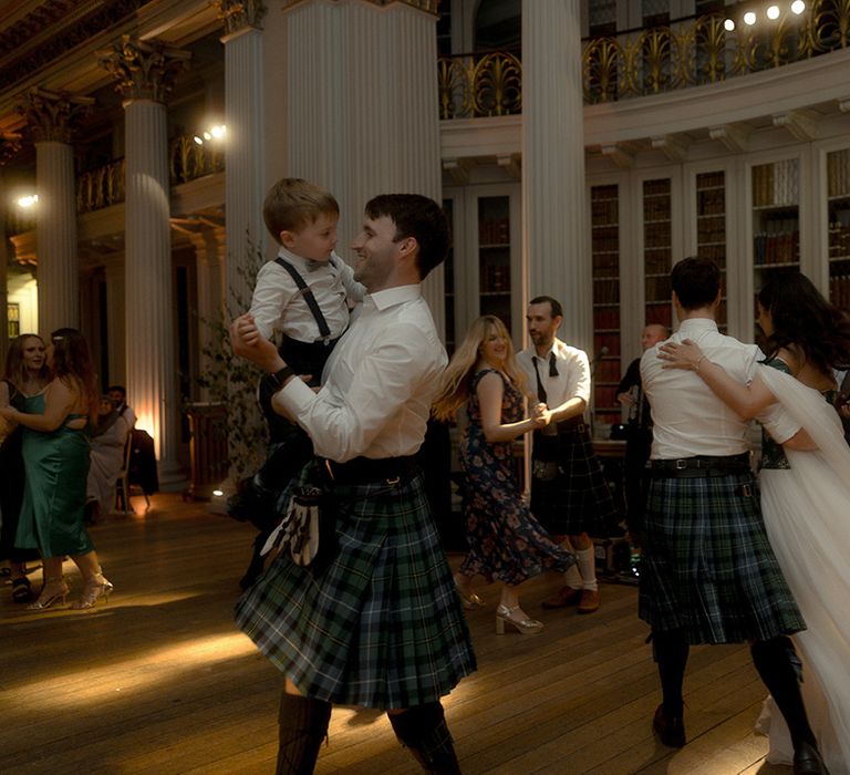 Bride and groom dancing at their wedding reception together 