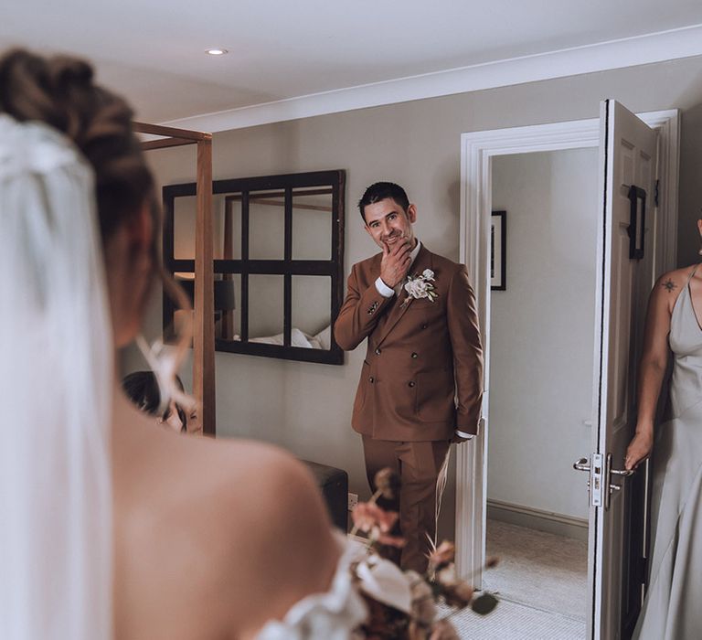 Father of the bride in a dark chocolate brown wedding suit sees bride for the first time 