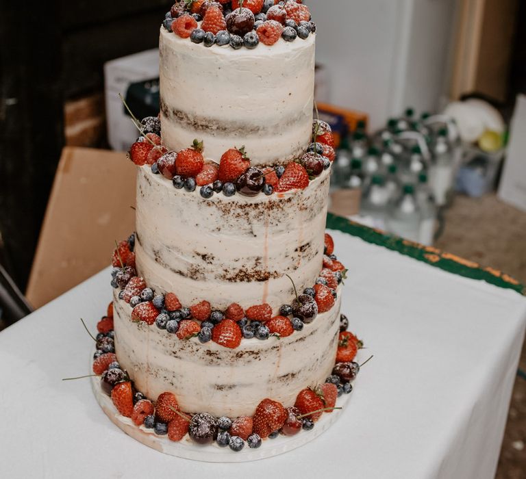 Semi naked wedding cake with fruit topper