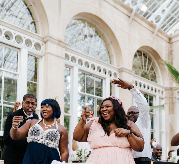 Wedding guests drinking shots at wedding reception