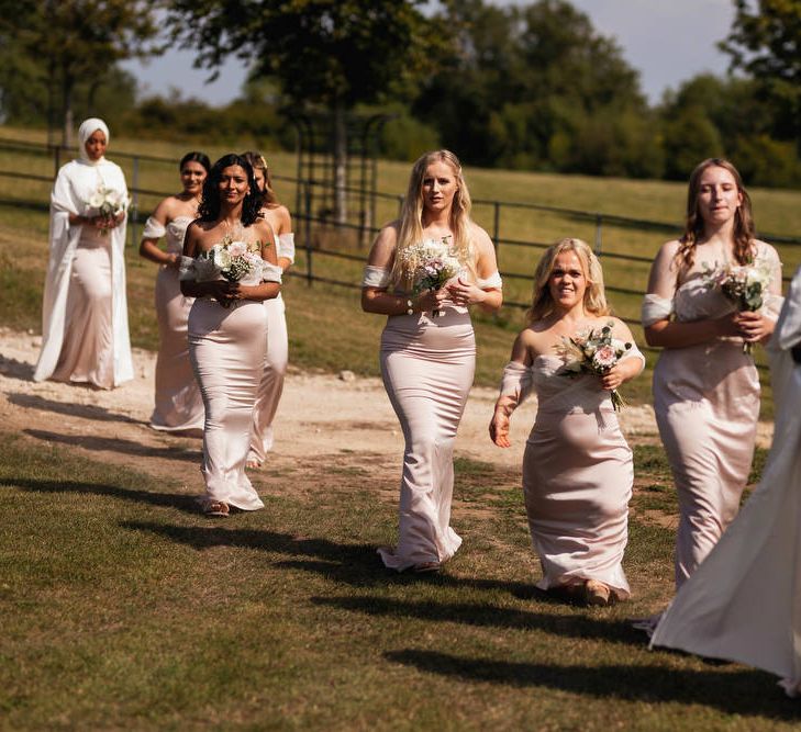 Bridesmaids entrance in pink dresses 