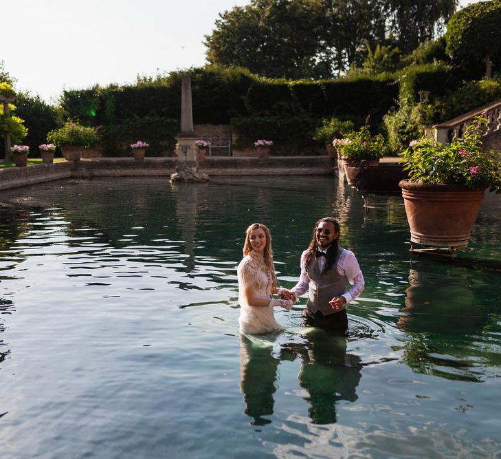 Bride and groom in the water at The Lost Orangery 