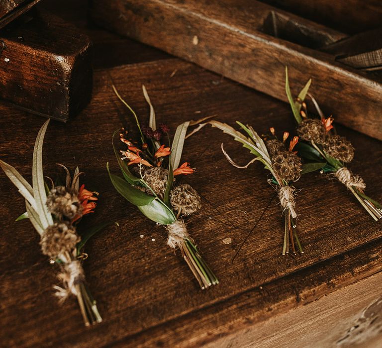 Dried flowers, foliage and orange buttonholes 