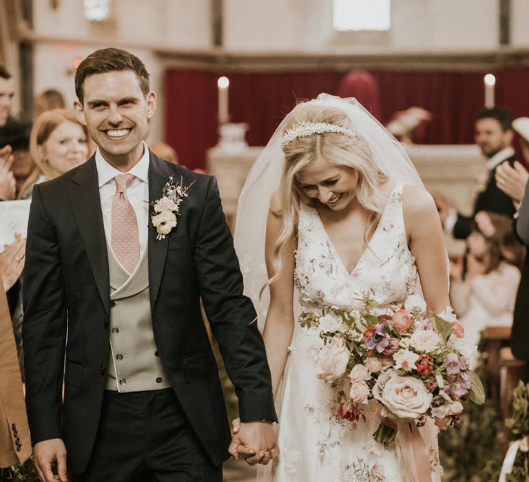 Confetti moment with bride in a floral embroidered wedding dress