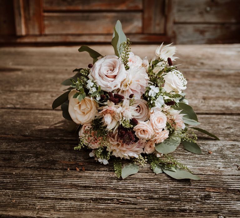 Romantic blush pink wedding bouquet with roses and dahlias 