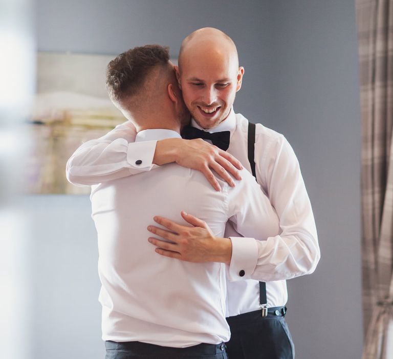 Same-sex couple hugging on their wedding morning 