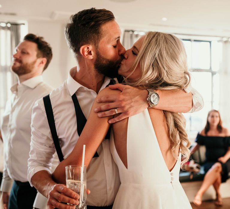 Bride & groom kiss during wedding reception