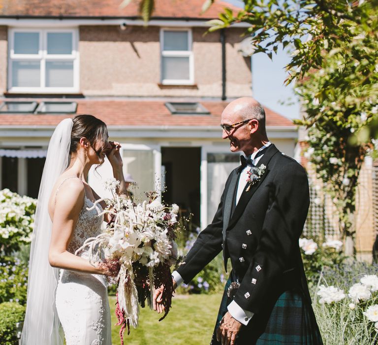 Father of the bride sees her for the first time on the morning of the wedding