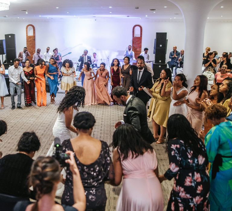 Bride and groom dancing at their Atrium reception surrounded by their wedding guests 