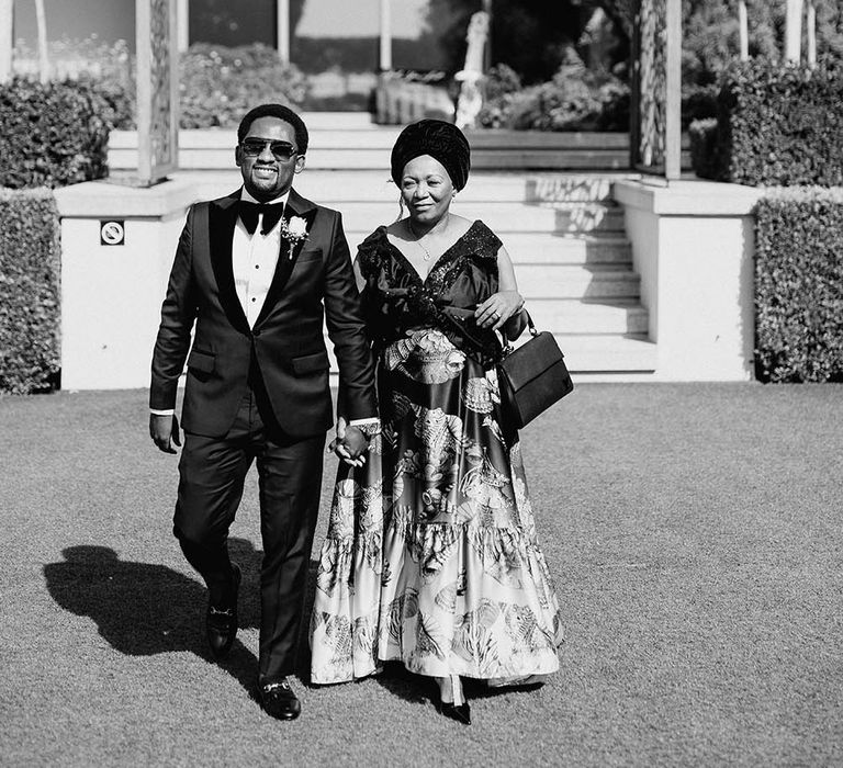 Mother-of-the-groom and the groom walking down the aisle 