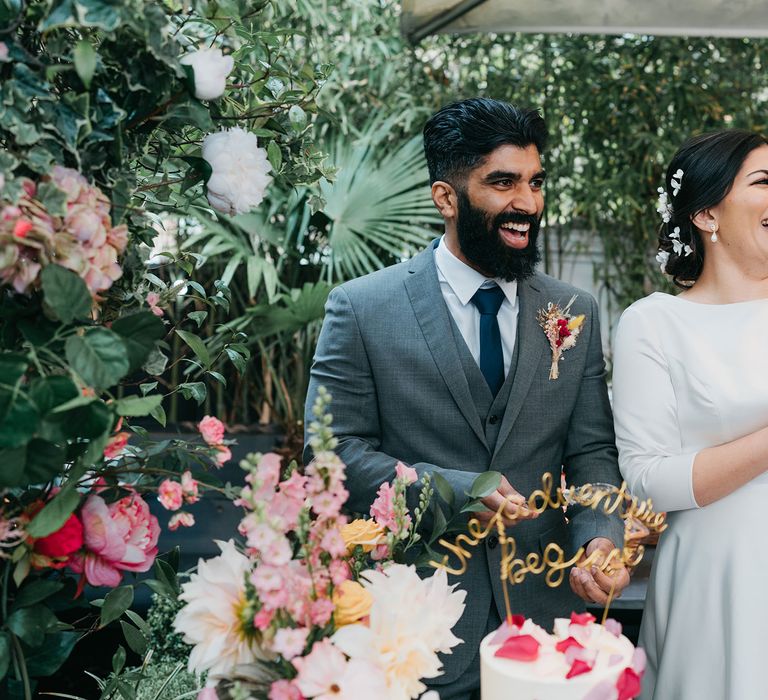 Bride & groom wait to cut cake at The Phene for their wedding reception with botanical vibes